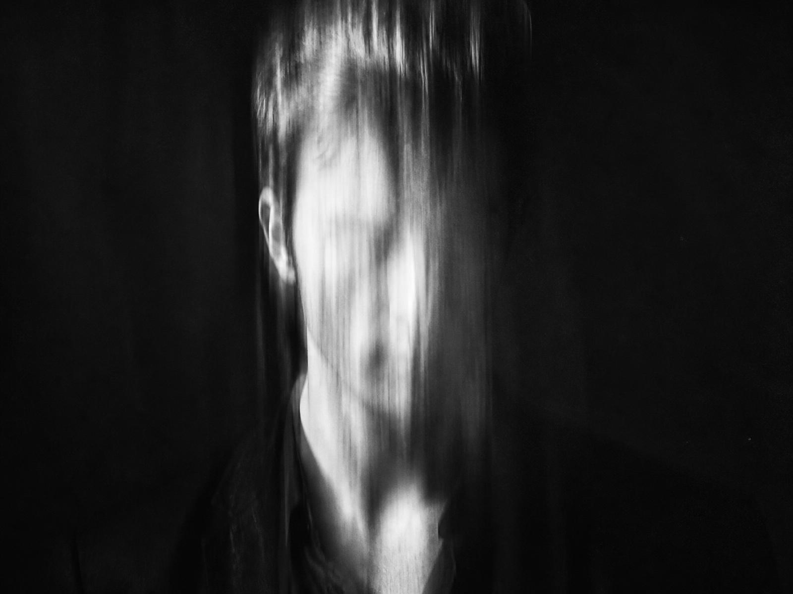 Motion-blurred black and white portrait of a man